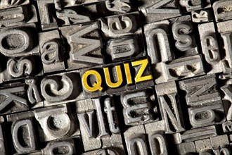Old lead letters forming the word 'QUIZ'