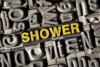 Old lead letters forming the word 'SHOWER'