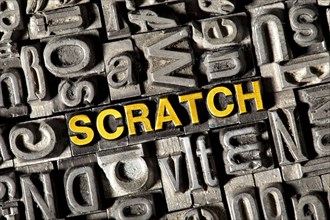 Old lead letters forming the word 'SCRATCH'