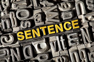 Old lead letters forming the word 'SENTENCE'