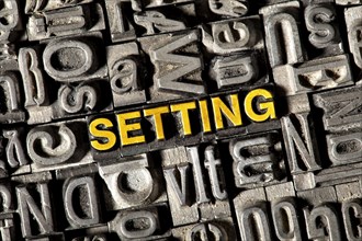 Old lead letters forming the word 'SETTING'