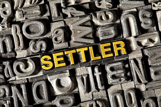 Old lead letters forming the word 'SETTLER'