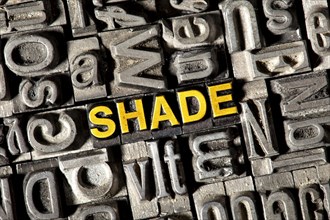 Old lead letters forming the word 'SHADE'
