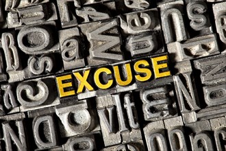 Old lead letters forming the word 'EXCUSE'