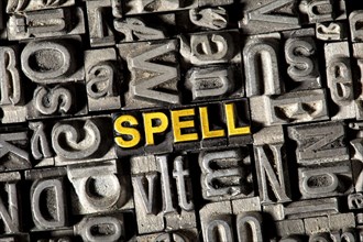 Old lead letters forming the word 'SPELL'