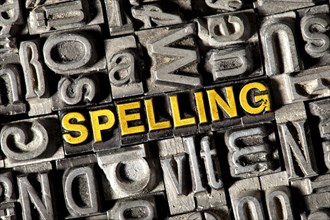 Old lead letters forming the word 'SPELLING'
