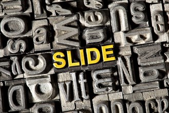 Old lead letters forming the word "SLIDE"