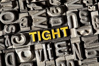 Old lead letters forming the word 'TIGHT'