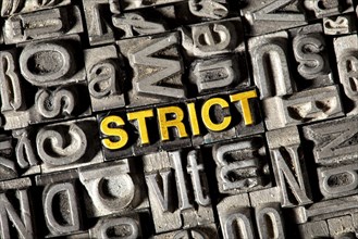 Old lead letters forming the word 'STRICT'