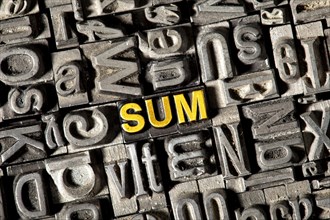 Old lead letters forming the word 'SUM'