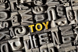 Old lead letters forming the word Toy