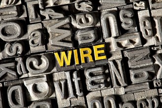 Old lead letters forming the word "wire"