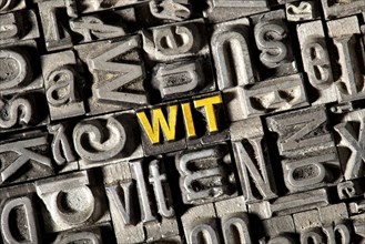 Old lead letters forming the word 'wit'