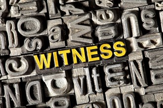 Old lead letters forming the word 'witness'