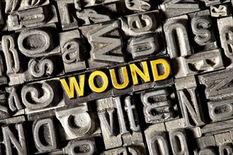 Old lead letters forming the word 'wound'