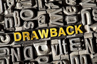 Old lead letters forming the word Drawback