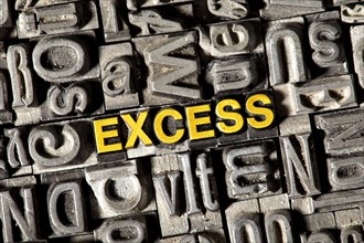 Old lead letters forming the word Excess