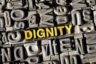 Old lead letters forming the word Dignity