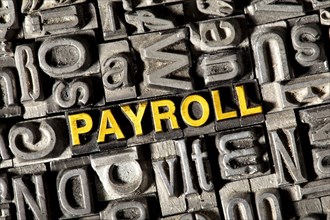 Old lead letters forming the word "PAYROLL"