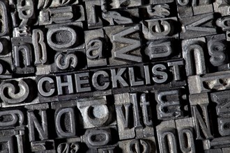 Old lead letters forming the word CHECKLIST