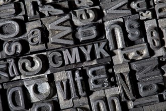 Old lead letters forming the term CMYK