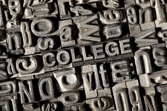 Old lead letters forming the word COLLEGE