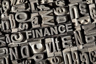Old lead letters forming the word FINANCE
