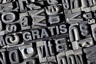 Old lead letters forming the word GRATIS