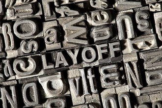 Old lead letters forming the word 'LAYOFF'