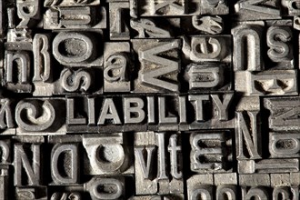 Old lead letters forming the word 'LIABILITY'