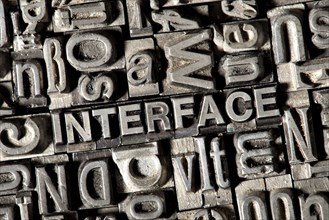 Old lead letters forming the word 'INTERFACE'