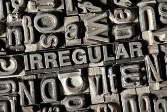 Old lead letters forming the word 'IRREGULAR'