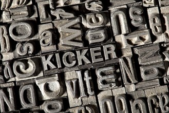 Old lead letters forming the word "KICKER"