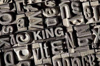 Old lead letters forming the word 'KING'