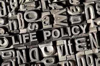Old lead letters forming the words "LIFE POLICY"