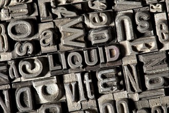 Old lead letters forming the word 'LIQUID'