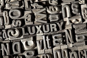 Old lead letters forming the word 'LUXURY'