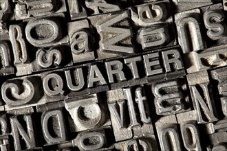 Old lead letters forming the word 'QUARTER'