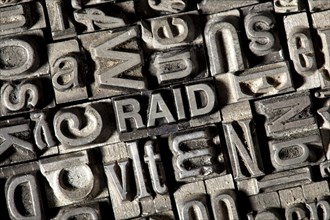 Old lead letters forming the word 'RAID'