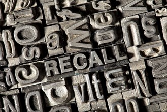 Old lead letters forming the word 'RECALL'