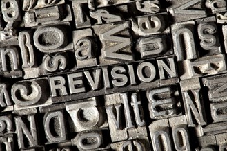 Old lead letters forming the word REVISION