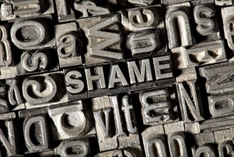 Old lead letters forming the word SHAME