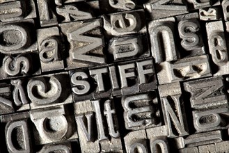 Old lead letters forming the word 'STIFF'