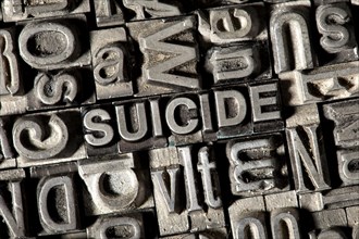 Old lead letters forming the word "SUICIDE"