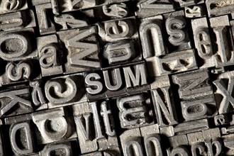 Old lead letters forming the word 'SUM'