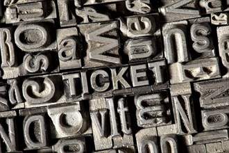 Old lead letters forming the word TICKET