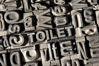 Old lead letters forming the word TOILET