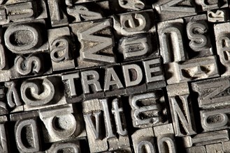 Old lead letters forming the word TRADE