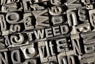 Old lead letters forming the word TWEED