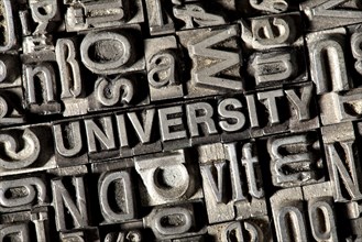 Old lead letters forming the word UNIVERSITY